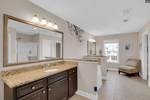 bathroom with visible vents, baseboards, an enclosed shower, and tile patterned flooring