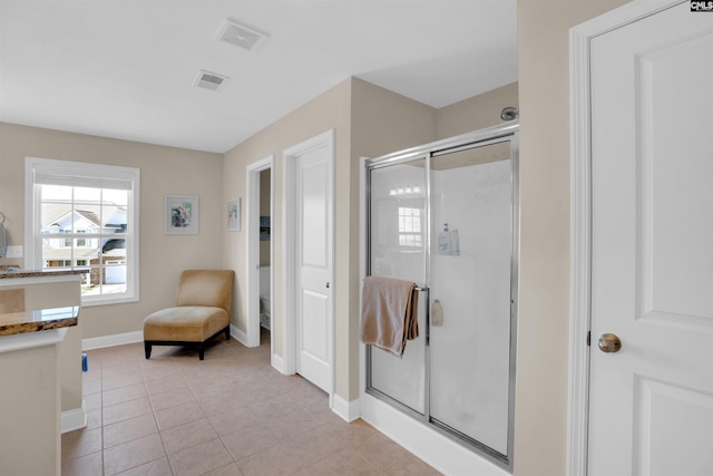 full bathroom featuring tile patterned floors, visible vents, baseboards, and a stall shower