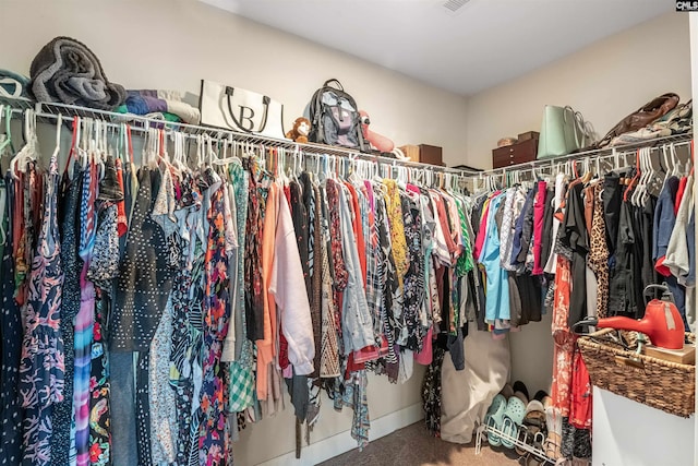 spacious closet with carpet floors