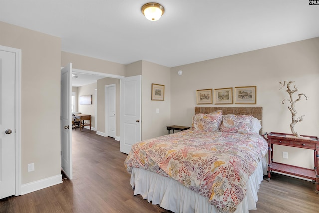 bedroom with wood finished floors and baseboards