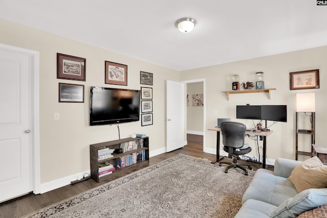 office area featuring baseboards and wood finished floors