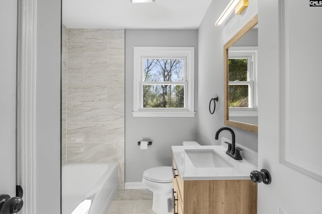 bathroom featuring a wealth of natural light, baseboards, toilet, and vanity