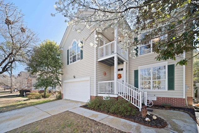 traditional-style home with crawl space, driveway, an attached garage, and a balcony