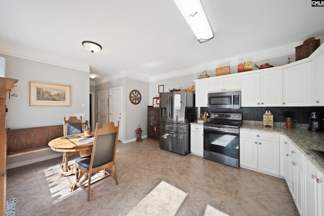 kitchen with ornamental molding, white cabinetry, appliances with stainless steel finishes, decorative backsplash, and light stone countertops