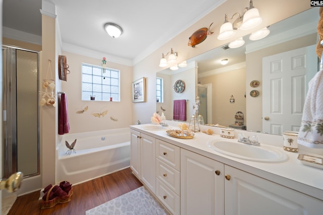 bathroom with a bath, a stall shower, double vanity, and a sink