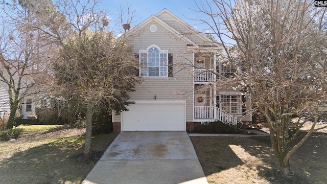 view of front of house with a front lawn, driveway, an attached garage, and a balcony