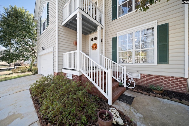 entrance to property with a balcony and concrete driveway