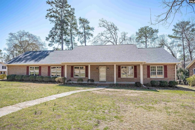 single story home with a front lawn, brick siding, and roof with shingles