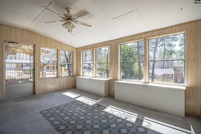 unfurnished sunroom featuring a ceiling fan and vaulted ceiling