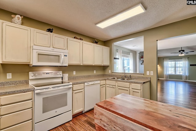 kitchen with white appliances, ceiling fan, a sink, light wood-style floors, and a textured ceiling