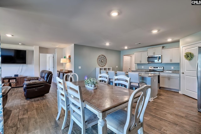 dining area featuring recessed lighting and dark wood-style flooring