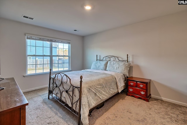 bedroom with carpet flooring, baseboards, and visible vents