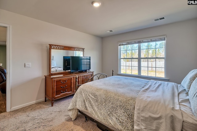 carpeted bedroom featuring baseboards and visible vents