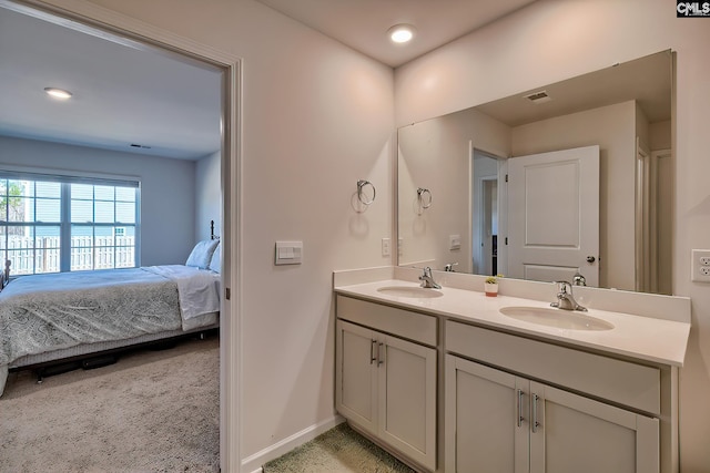 ensuite bathroom with ensuite bath, double vanity, visible vents, and a sink