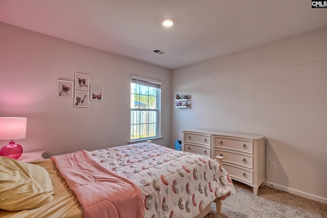 bedroom featuring visible vents, light colored carpet, and baseboards