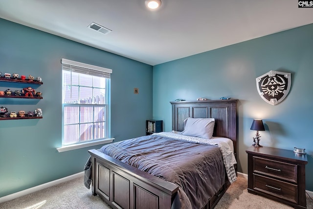 bedroom with light colored carpet, baseboards, and visible vents