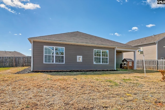 back of property featuring a lawn and a fenced backyard