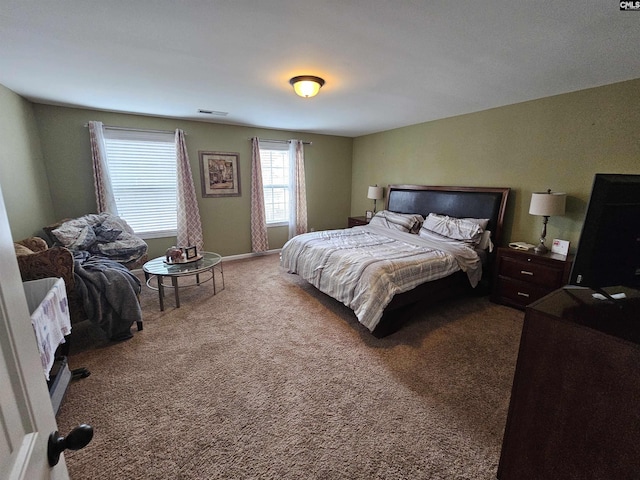 carpeted bedroom with visible vents and baseboards