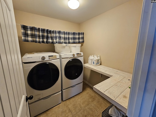 clothes washing area with light tile patterned flooring, laundry area, and separate washer and dryer