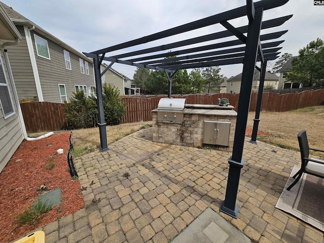 view of patio with area for grilling, a pergola, and a fenced backyard