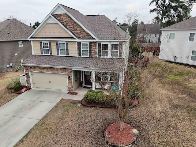 craftsman-style home featuring a garage, roof with shingles, and concrete driveway