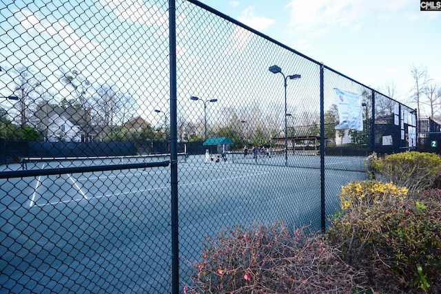 view of sport court with fence