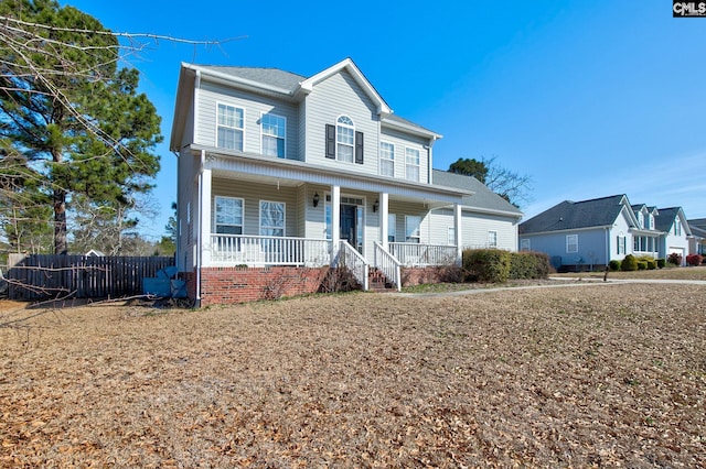 view of front of house featuring fence and covered porch