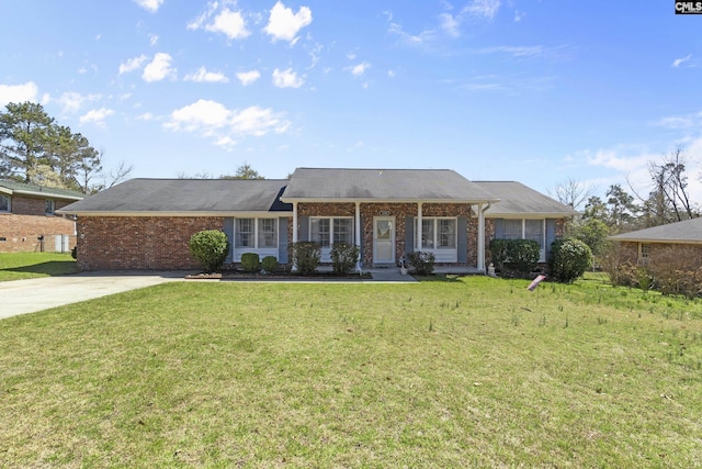 ranch-style home with brick siding, concrete driveway, and a front lawn