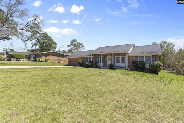 ranch-style house with brick siding and a front lawn