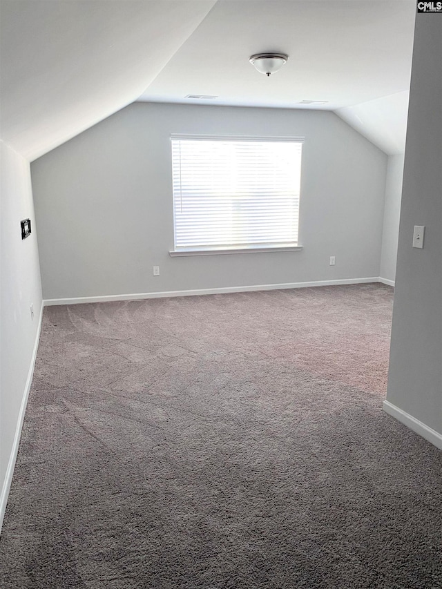 bonus room with vaulted ceiling, carpet flooring, visible vents, and baseboards