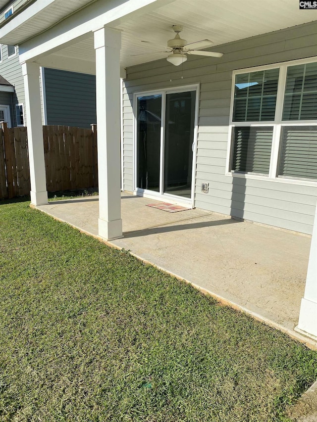 view of patio / terrace with a ceiling fan and fence