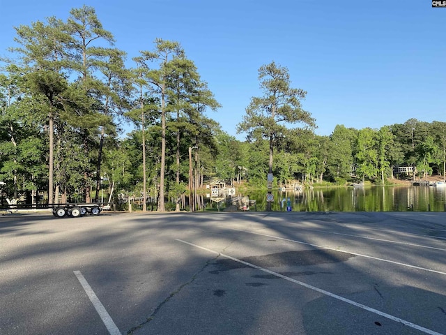 view of street featuring a forest view and a water view