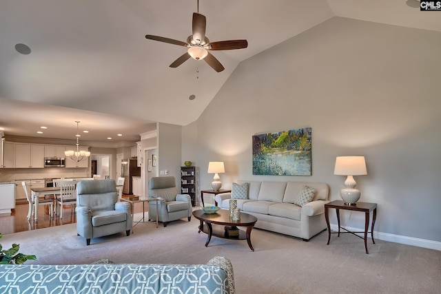 living room with recessed lighting, baseboards, high vaulted ceiling, and ceiling fan with notable chandelier