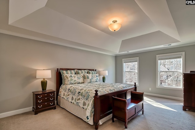 bedroom with a tray ceiling, light colored carpet, visible vents, and baseboards