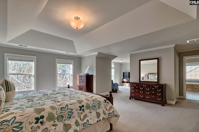 carpeted bedroom with a tray ceiling, crown molding, visible vents, and baseboards