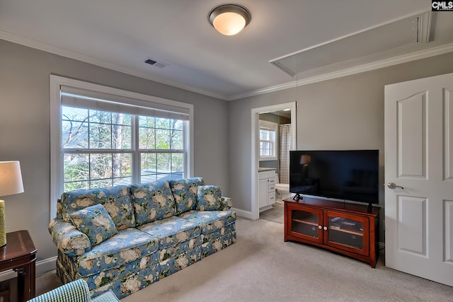 living area with light carpet, visible vents, attic access, and ornamental molding