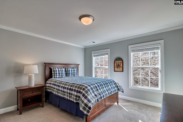 bedroom featuring light carpet, visible vents, baseboards, and ornamental molding