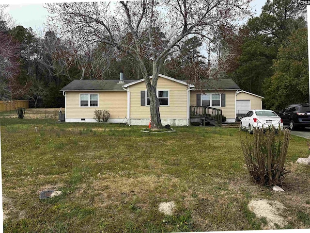 view of front of home with a garage and a front lawn