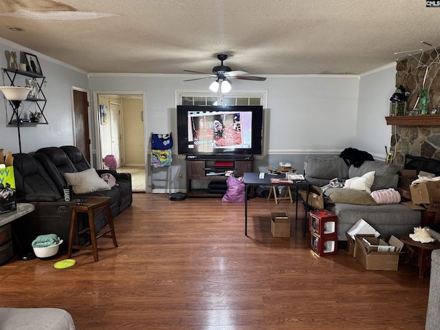 living area with a textured ceiling, crown molding, and wood finished floors