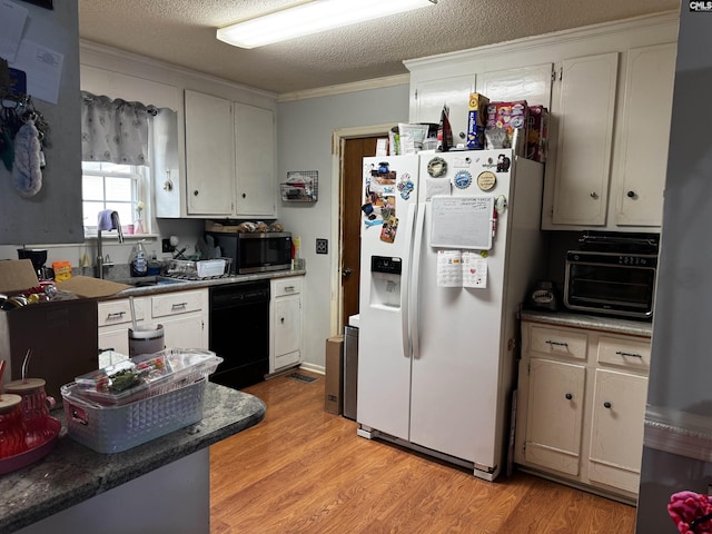 kitchen with stainless steel microwave, crown molding, black dishwasher, white refrigerator with ice dispenser, and a sink