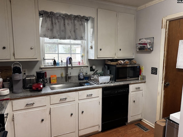 kitchen featuring visible vents, ornamental molding, a sink, dishwasher, and stainless steel microwave