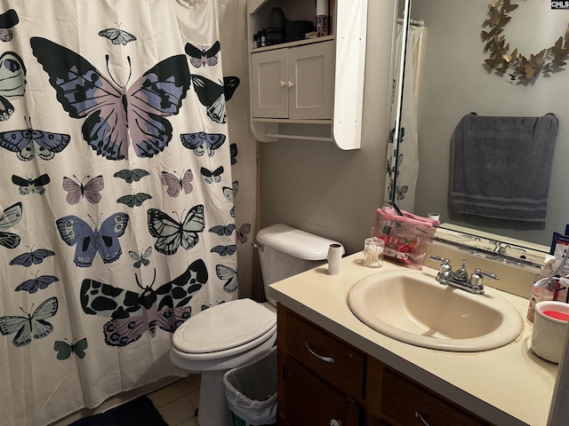 full bath with a shower with shower curtain, toilet, vanity, and tile patterned flooring