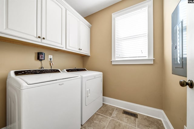 washroom featuring washer and clothes dryer, visible vents, cabinet space, and baseboards