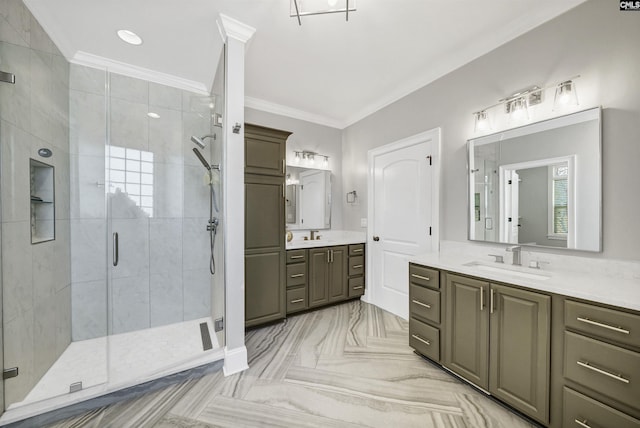 bathroom featuring a shower stall, two vanities, crown molding, and a sink