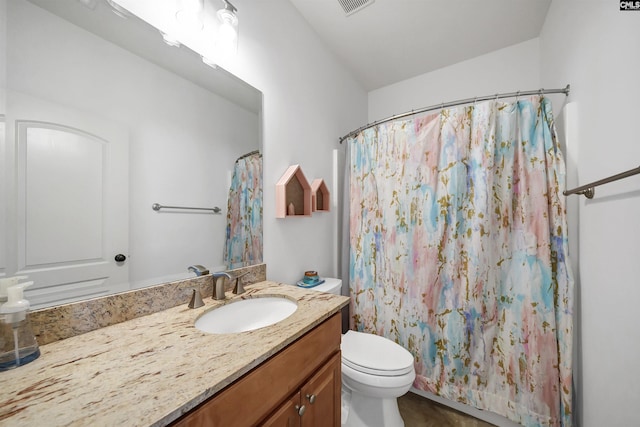 bathroom with curtained shower, toilet, vanity, and vaulted ceiling