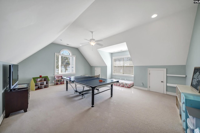 playroom featuring baseboards, light colored carpet, ceiling fan, and vaulted ceiling