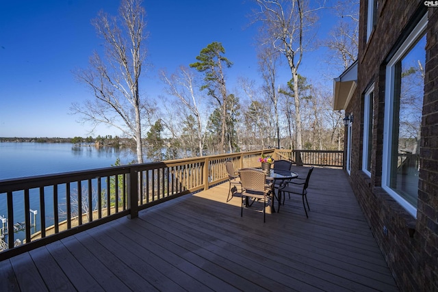 deck featuring a water view and outdoor dining space