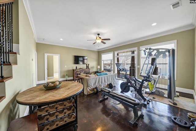 workout room with ceiling fan, baseboards, visible vents, and ornamental molding