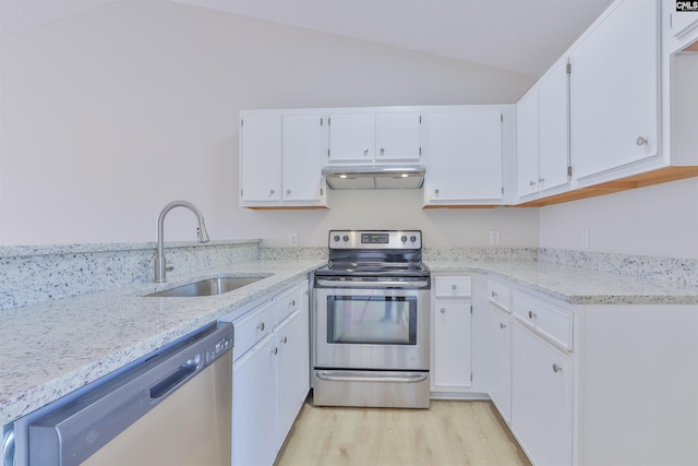 kitchen featuring a sink, light stone counters, appliances with stainless steel finishes, and under cabinet range hood