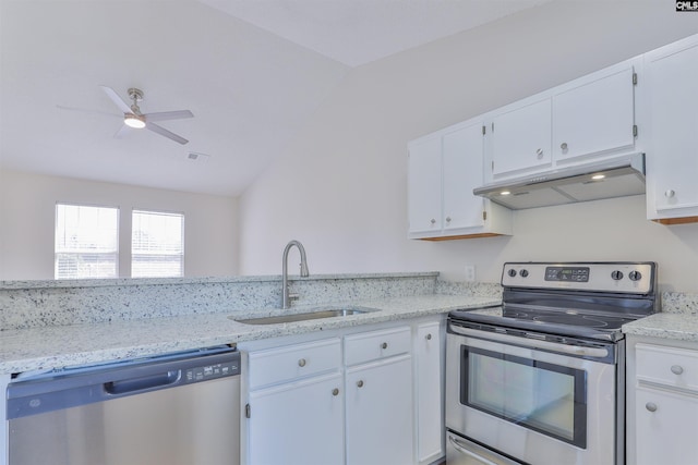 kitchen with a sink, vaulted ceiling, white cabinets, under cabinet range hood, and appliances with stainless steel finishes